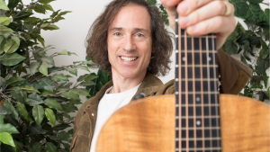 A man holding a guitar