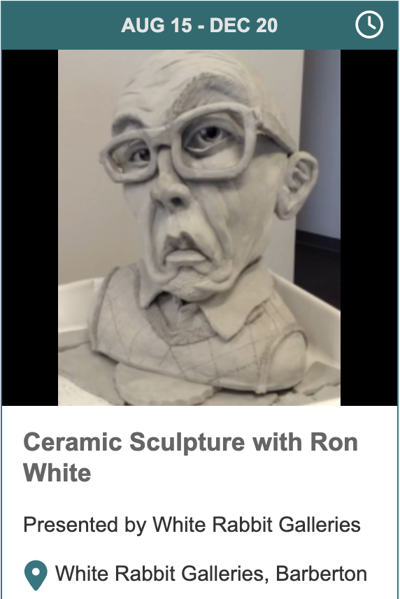 A ceramic sculpture of a man with glasses