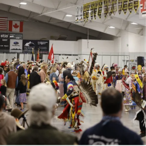 A photo from Buckrail new site of dancers and audience at the Teton Powow